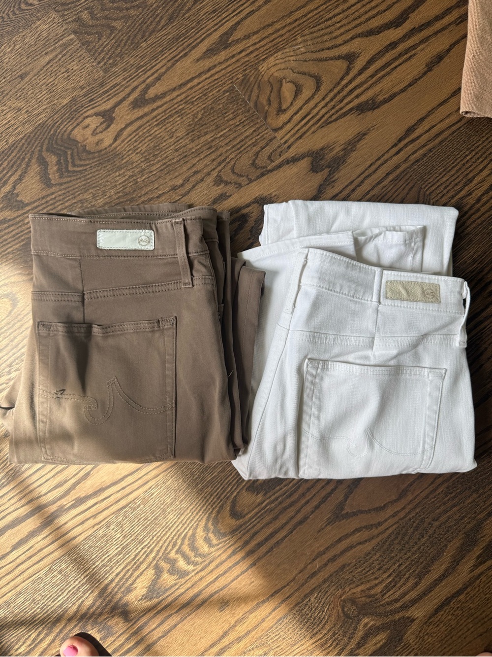 Two pairs of Ag Adriano Goldschmied Skinny Jeans in Brown and White